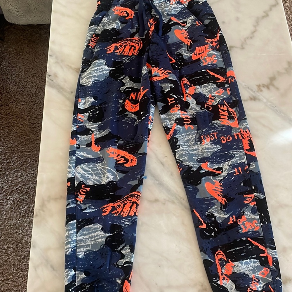 Color: dark blue and orange, size: youth large, condition: never worn.